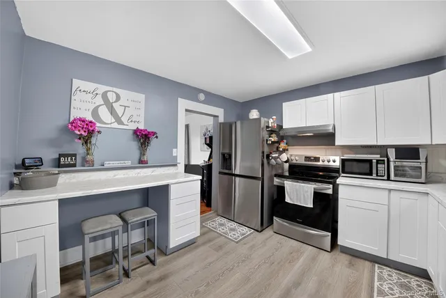 a kitchen with a sink cabinets and stainless steel appliances