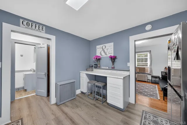 a view of a hallway and a livingroom with furniture