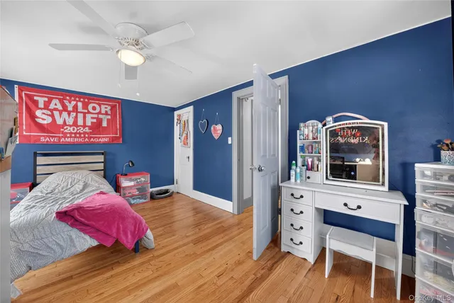 a bedroom with a bed a dresser and chair