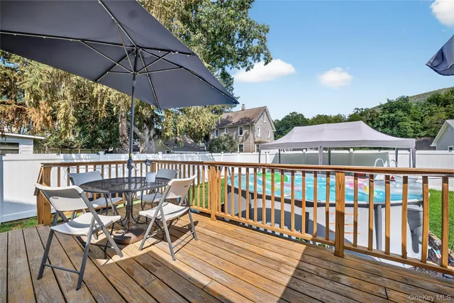 a view of a wooden deck with furniture