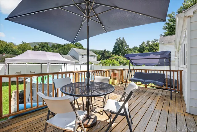a view of a balcony with furniture and wooden floor