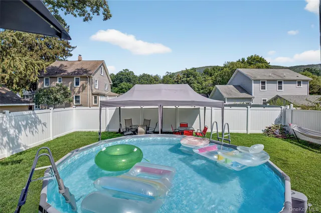 a view of a house with backyard sitting area and garden