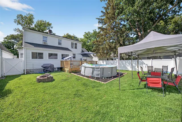 a backyard of a house with table and chairs