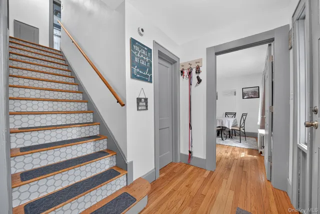 a view of a room with wooden floor and stairs
