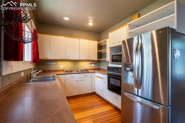 a kitchen with stainless steel appliances a stove and a refrigerator