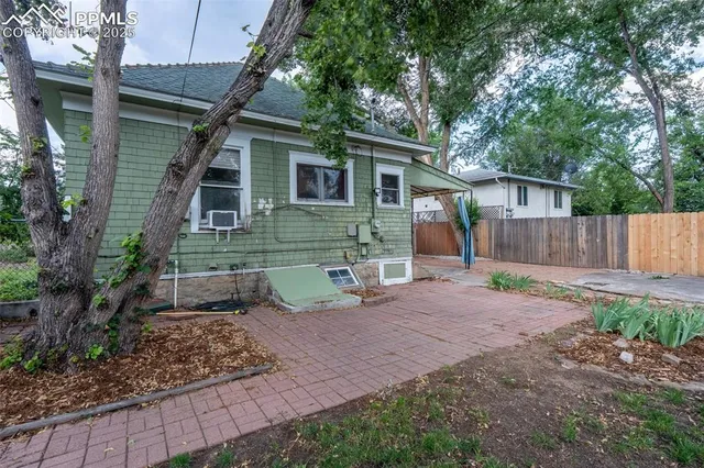 a view of a house with backyard and sitting area