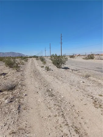 a view of a dry field with a view of road