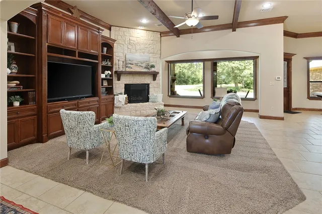 a dining room with furniture a fireplace and large windows