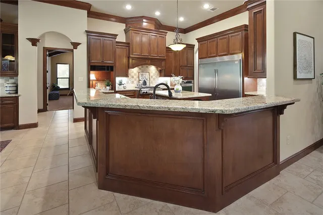 a kitchen with granite countertop a sink and cabinets