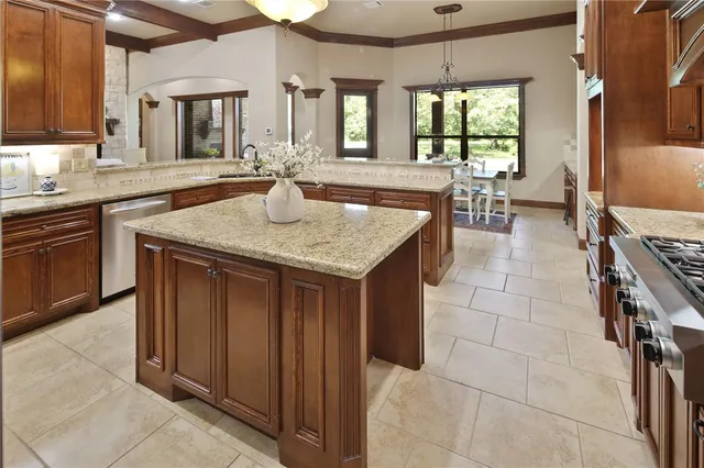 a kitchen with a sink counter top space and living room