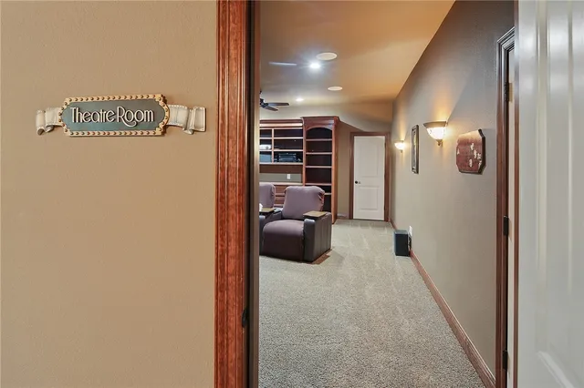 a living room with furniture and a ceiling fan