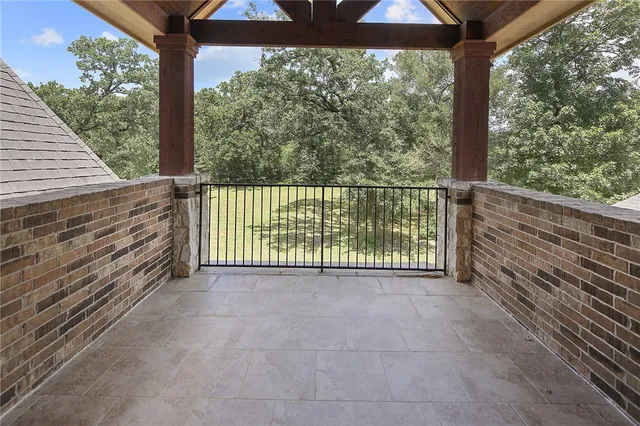 a view of a room with a wooden floor and outdoor space