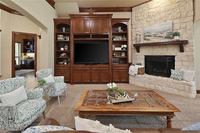 a living room with furniture a flat screen tv and a fireplace