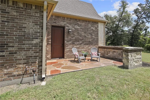 a view of a patio with table and chairs with wooden fence