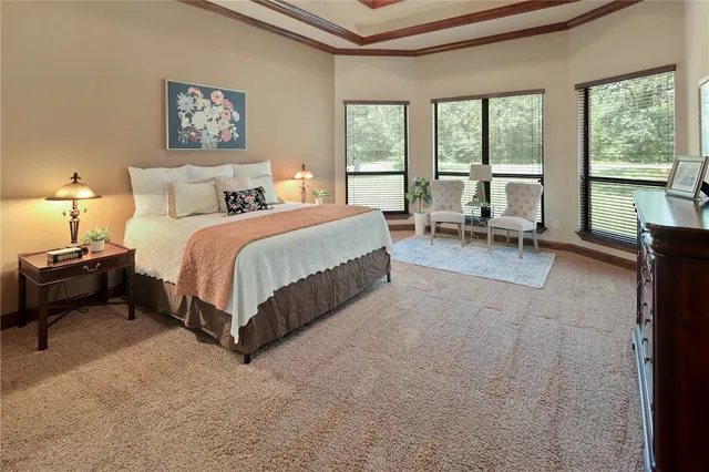 a spacious bedroom with a bed and a large window