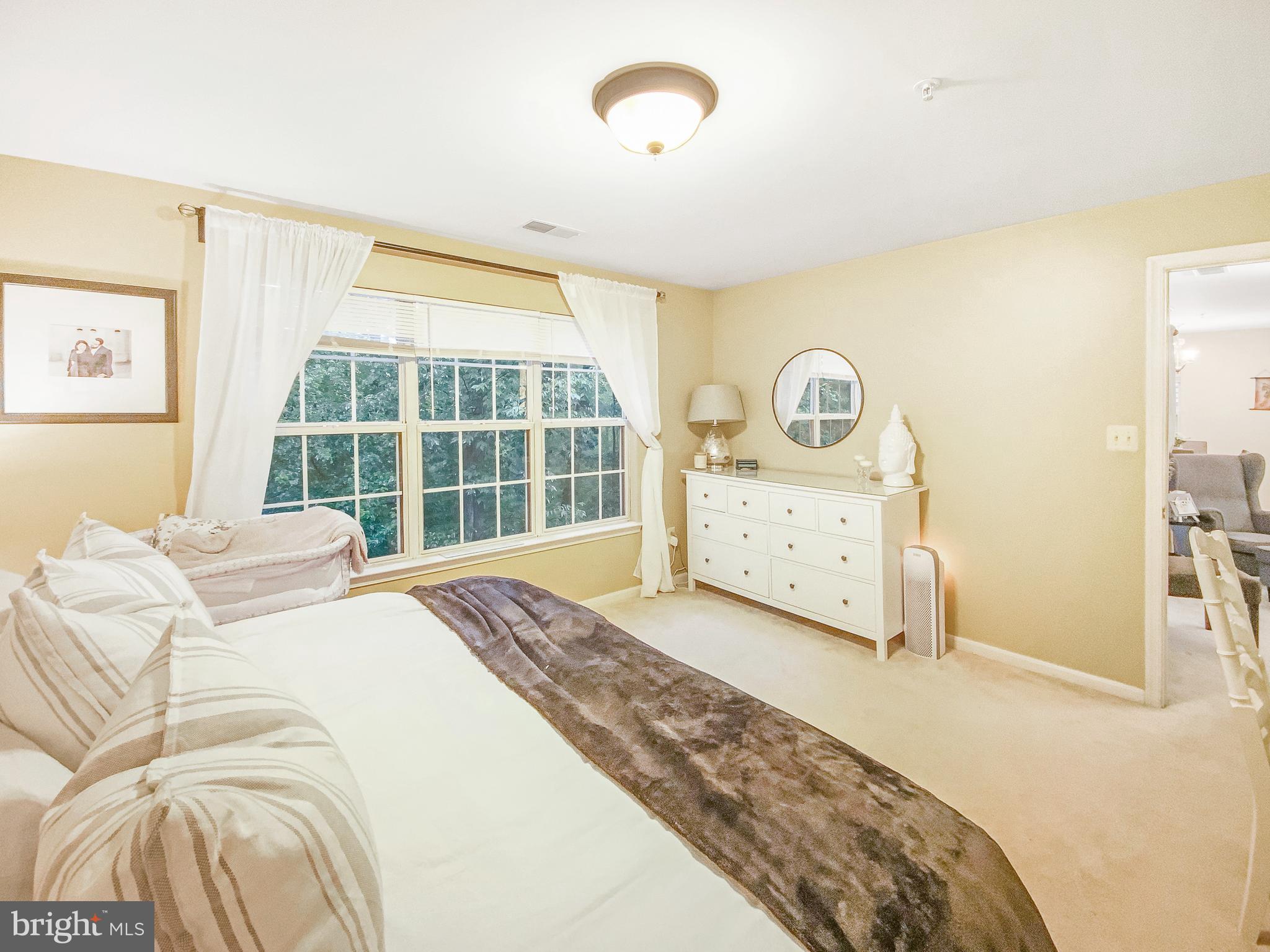 127 Timberbrook Lane, Unit 203 Gaithersburg, MD 20878 - Photo 11 of 29 a bedroom with a bed and a window