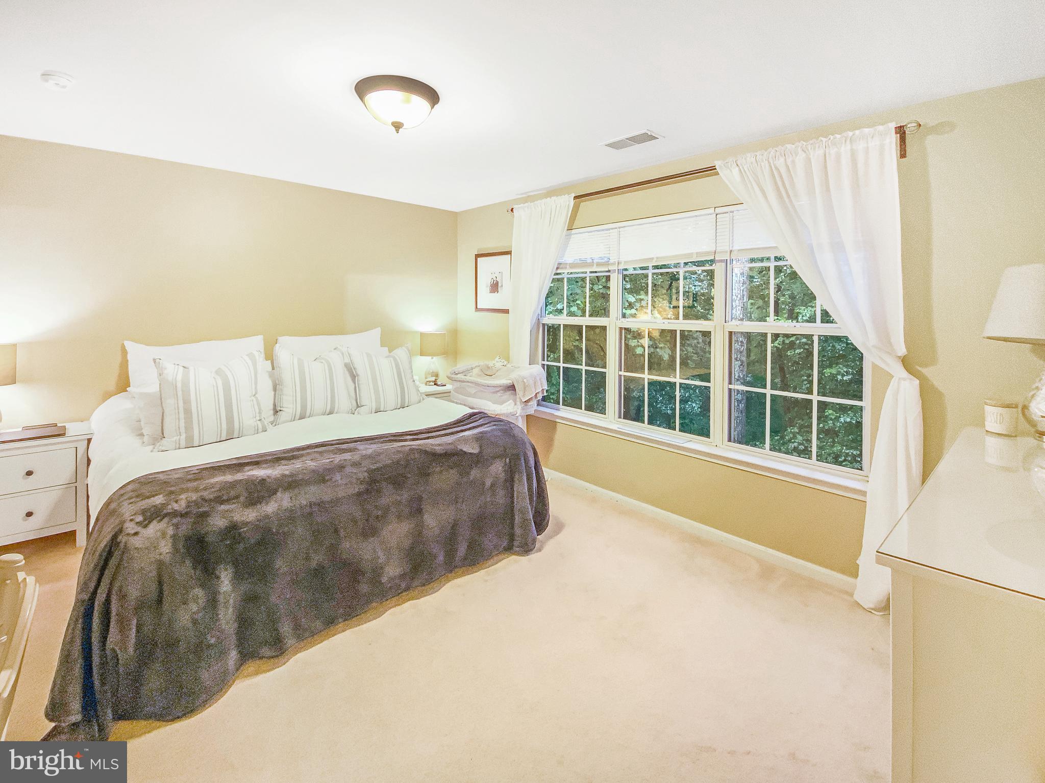 127 Timberbrook Lane, Unit 203 Gaithersburg, MD 20878 - Photo 12 of 29 a spacious bedroom with a large bed and a large window