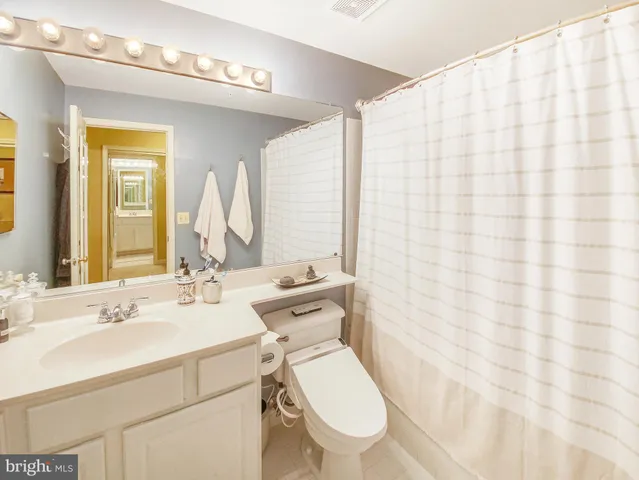 a spacious bedroom with a bed and a couch