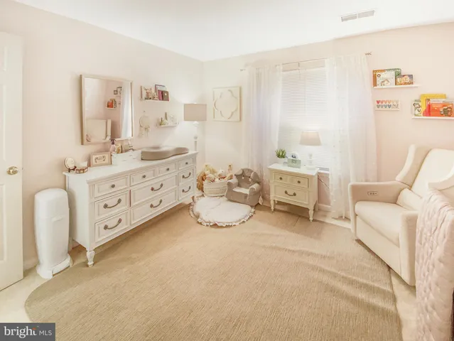 a bathroom with a granite countertop sink a toilet and a mirror