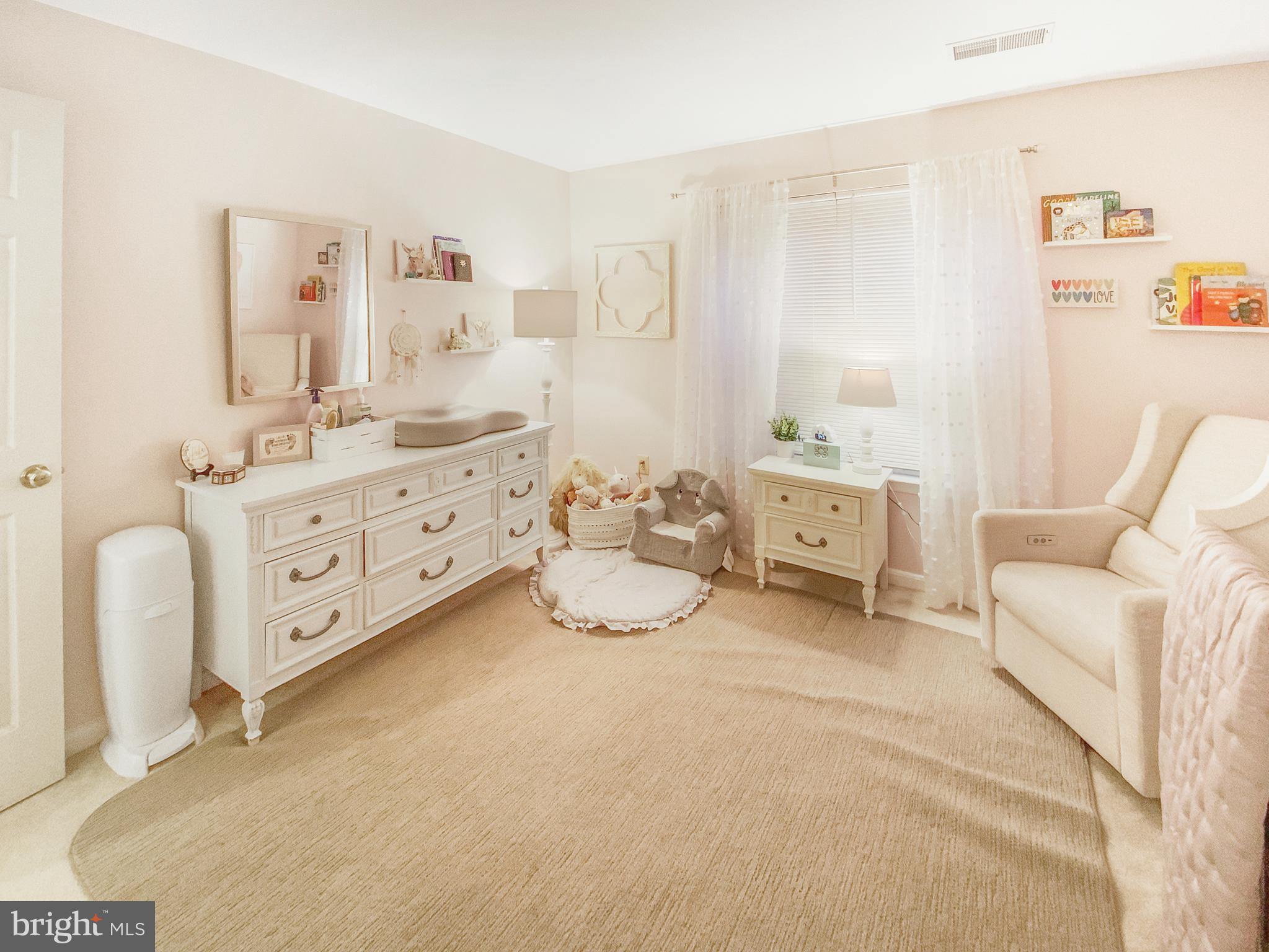 127 Timberbrook Lane, Unit 203 Gaithersburg, MD 20878 - Photo 14 of 29 a bedroom with a bed and a chair