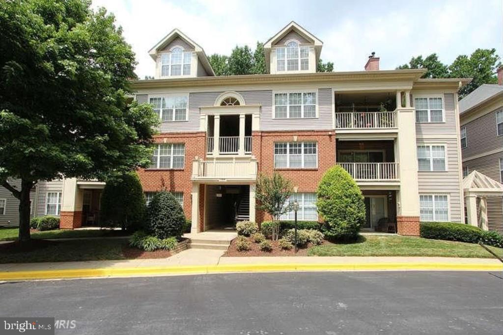 127 Timberbrook Lane, Unit 203 Gaithersburg, MD 20878 - Photo 25 of 29 a view of a white house with a large windows and a swimming pool