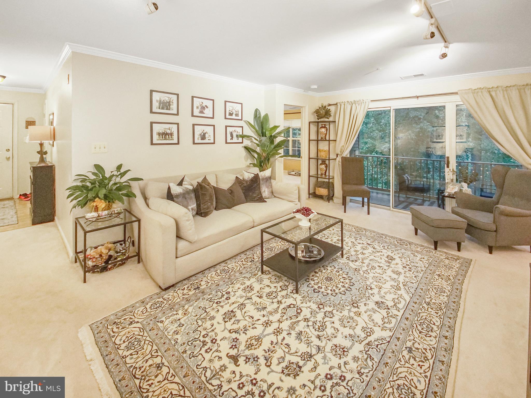 127 Timberbrook Lane, Unit 203 Gaithersburg, MD 20878 - Photo 7 of 29 a living room with furniture and a large window
