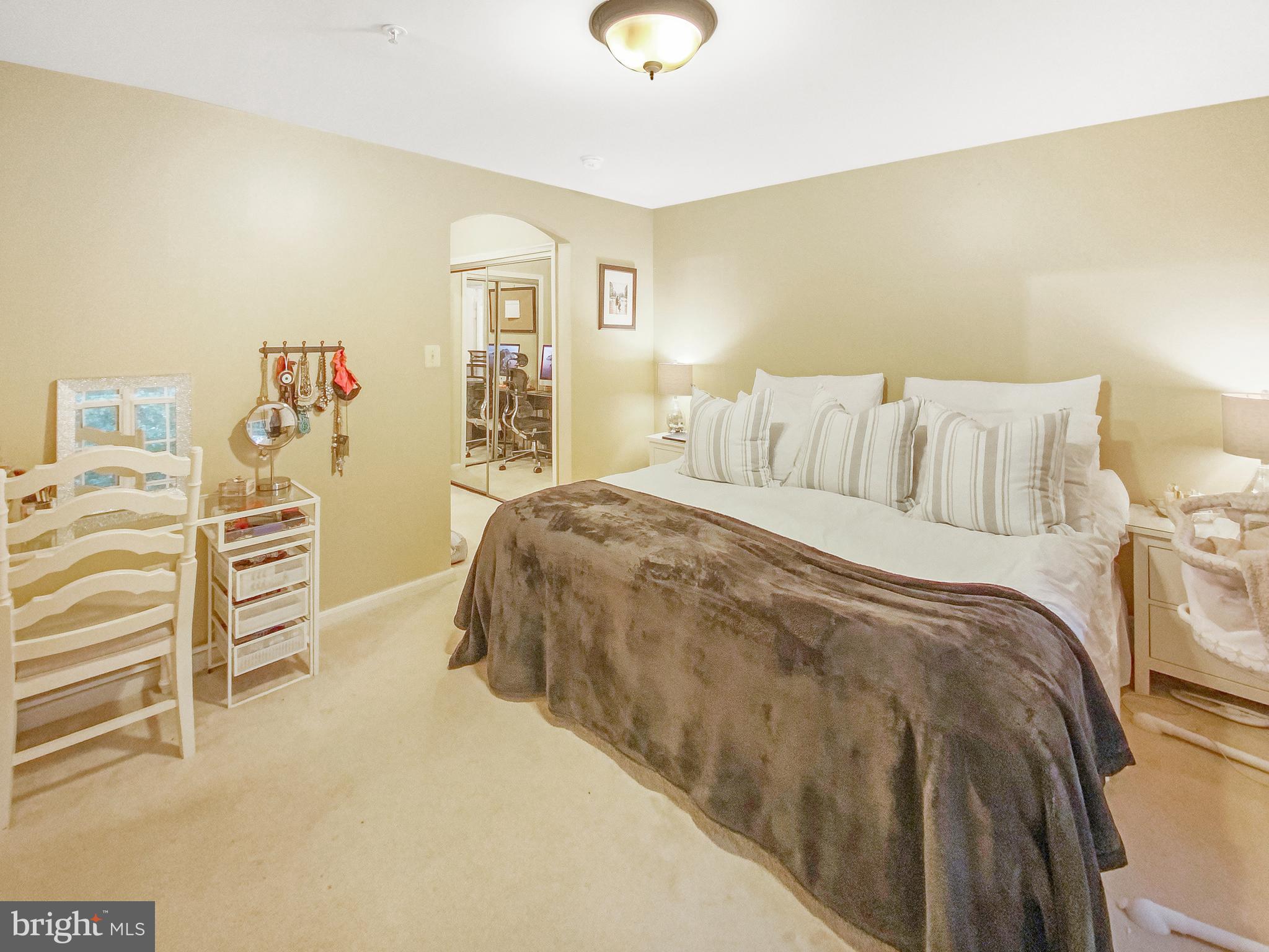 127 Timberbrook Lane, Unit 203 Gaithersburg, MD 20878 - Photo 10 of 29 a spacious bedroom with a bed and a cabinets