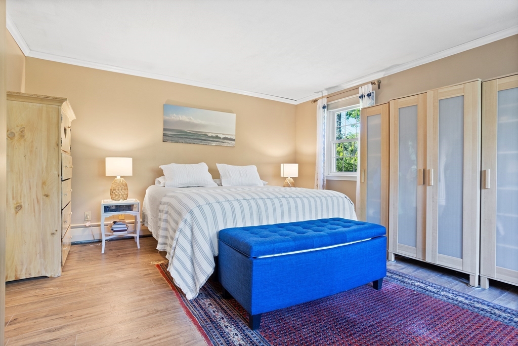 717 George Hill Road Lancaster, MA 01523 - Photo 26 of 36 a bedroom with a bed and wooden floor