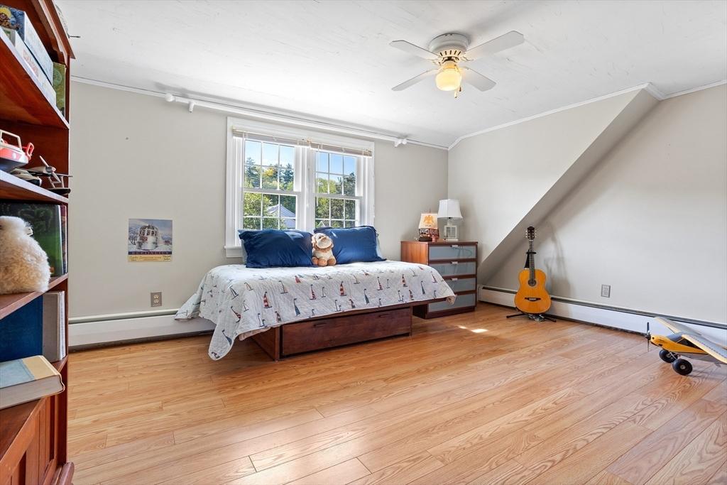 717 George Hill Road Lancaster, MA 01523 - Photo 29 of 36 a bedroom with a bed and a chandelier
