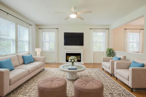 a view of an empty room with a chandelier fan