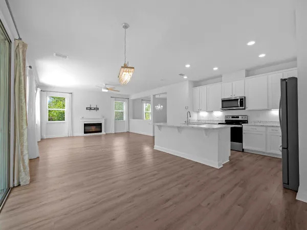 an empty room with a window and ceiling fan