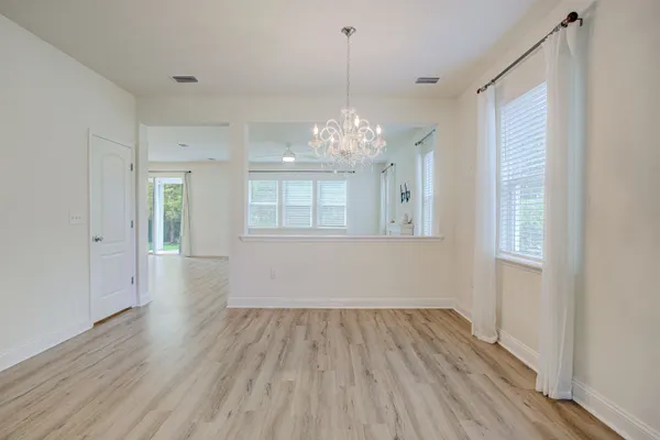 a view of kitchen with cabinets stainless steel appliances and wooden floor