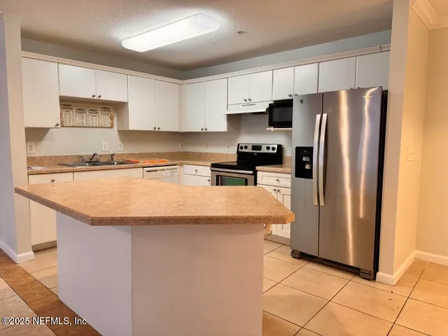 a kitchen with a sink and a stove