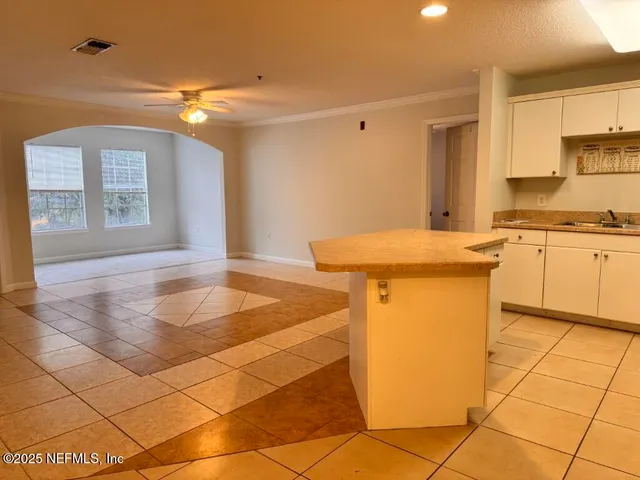 a view of kitchen with refrigerator and microwave