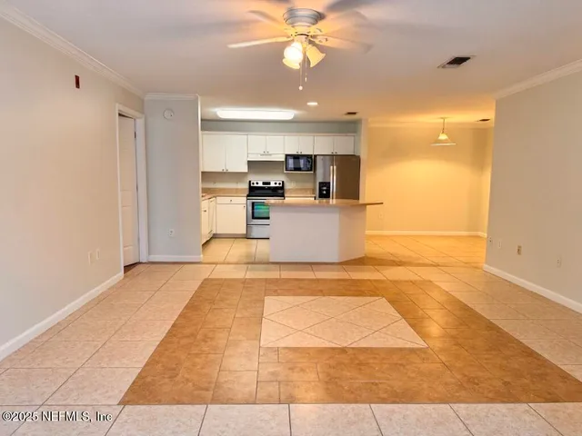 a open kitchen with kitchen island a sink stainless steel appliances and cabinets