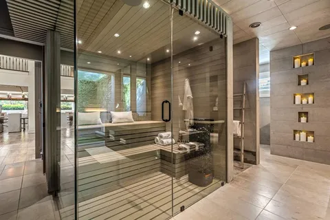 a bathroom with a granite countertop sink and a large mirror
