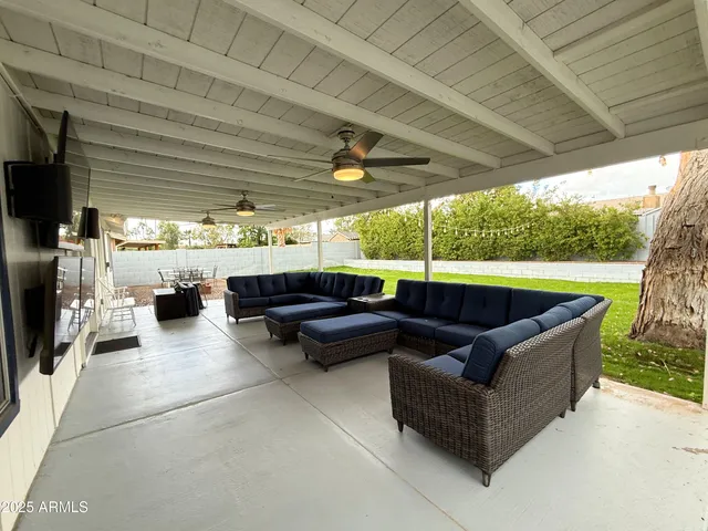 a building outdoor space with patio furniture and a garden
