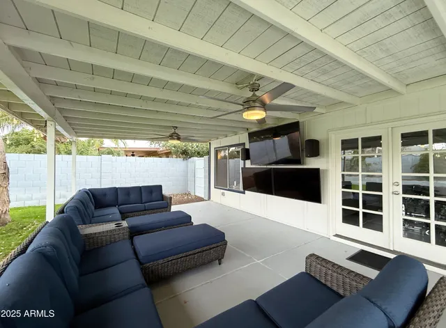 a outdoor living space with furniture and a rug
