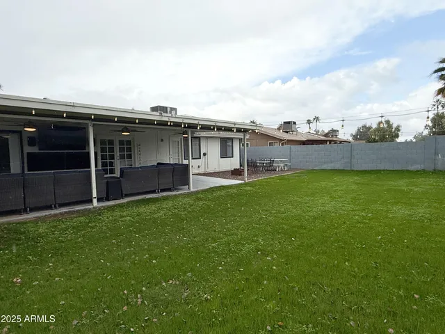 a view of a house with a yard and sitting area