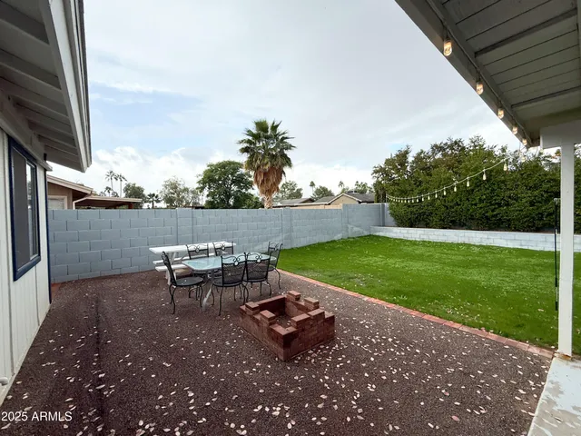 a view of a backyard with sitting area