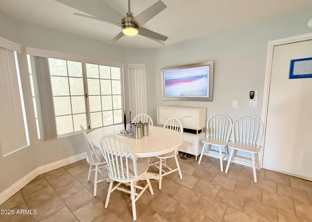 a view of a dining room with furniture and a window