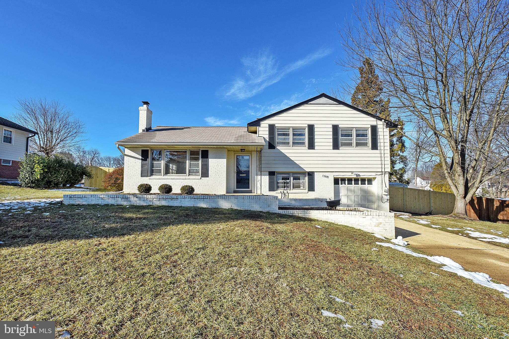 7308 Foxe Place Springfield, VA 22151 - Photo 1 of 38 a front view of a house with a yard