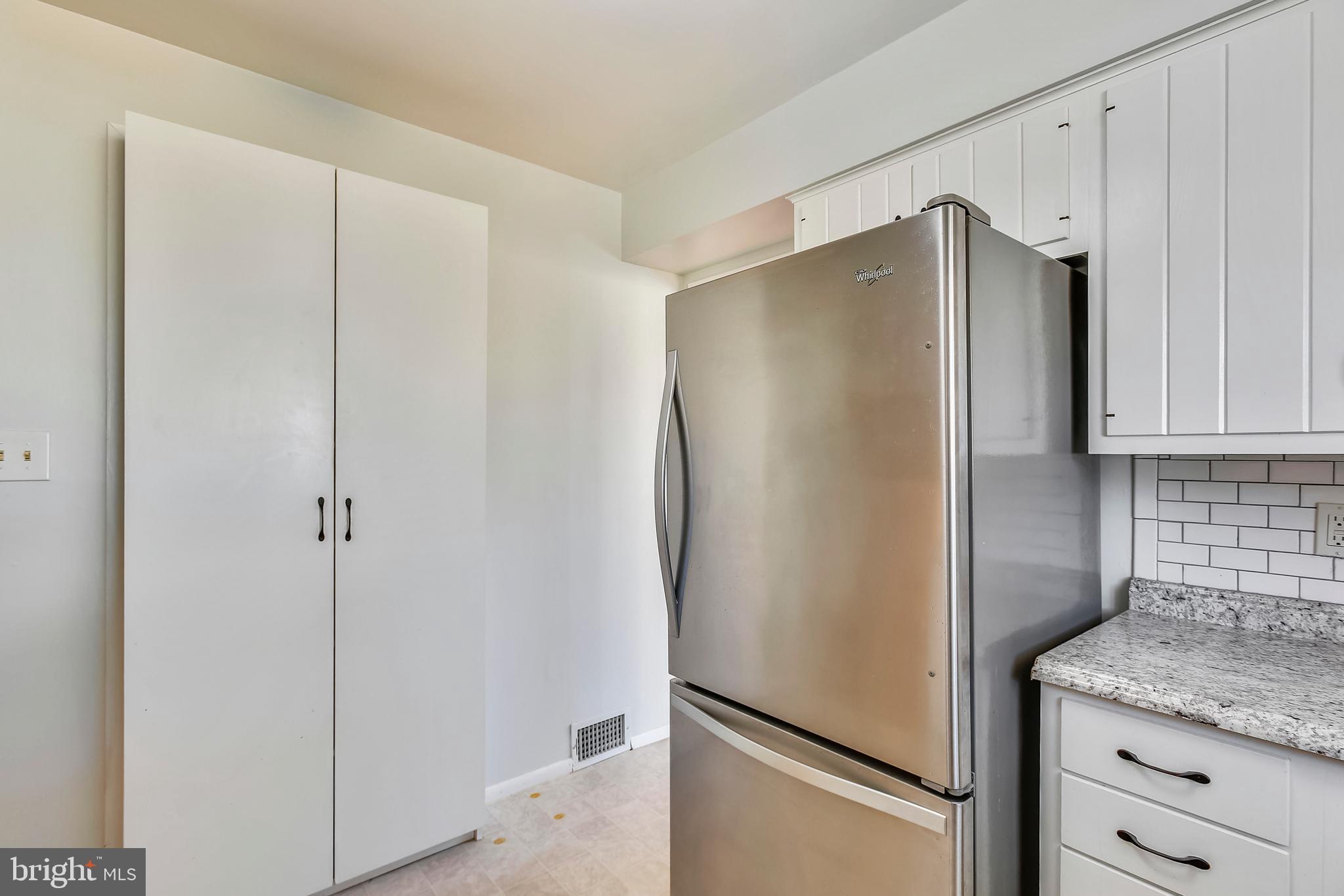 7308 Foxe Place Springfield, VA 22151 - Photo 12 of 38 a white refrigerator freezer sitting in a kitchen