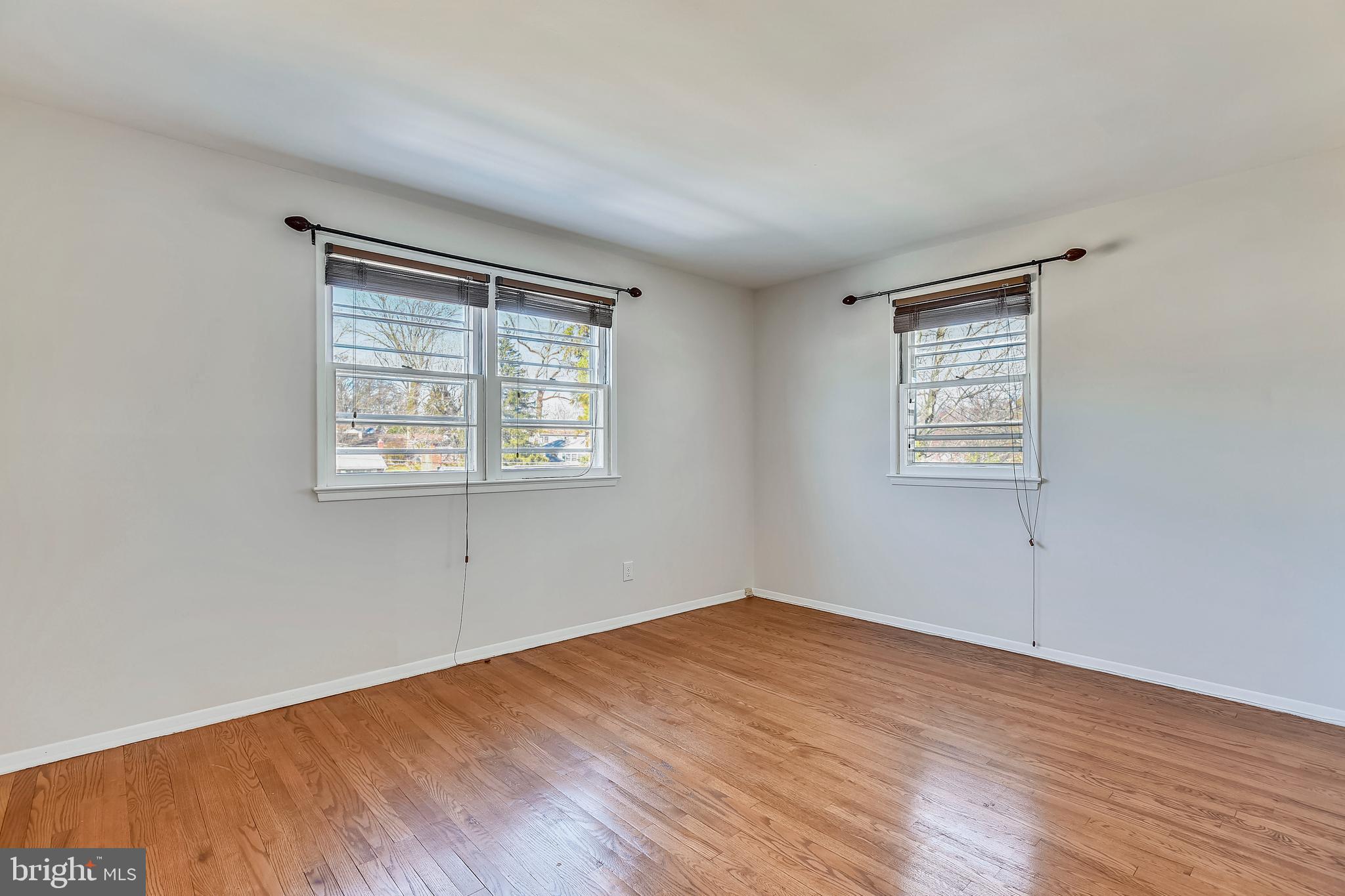 7308 Foxe Place Springfield, VA 22151 - Photo 23 of 38 an empty room with wooden floor and windows