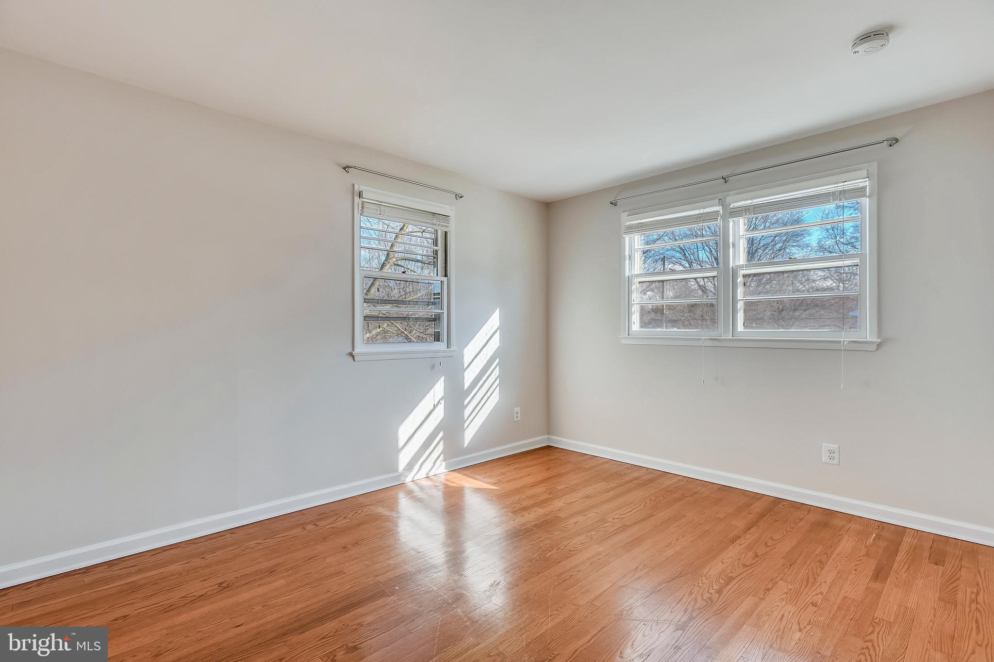 7308 Foxe Place Springfield, VA 22151 - Photo 24 of 38 an empty room with wooden floor and windows