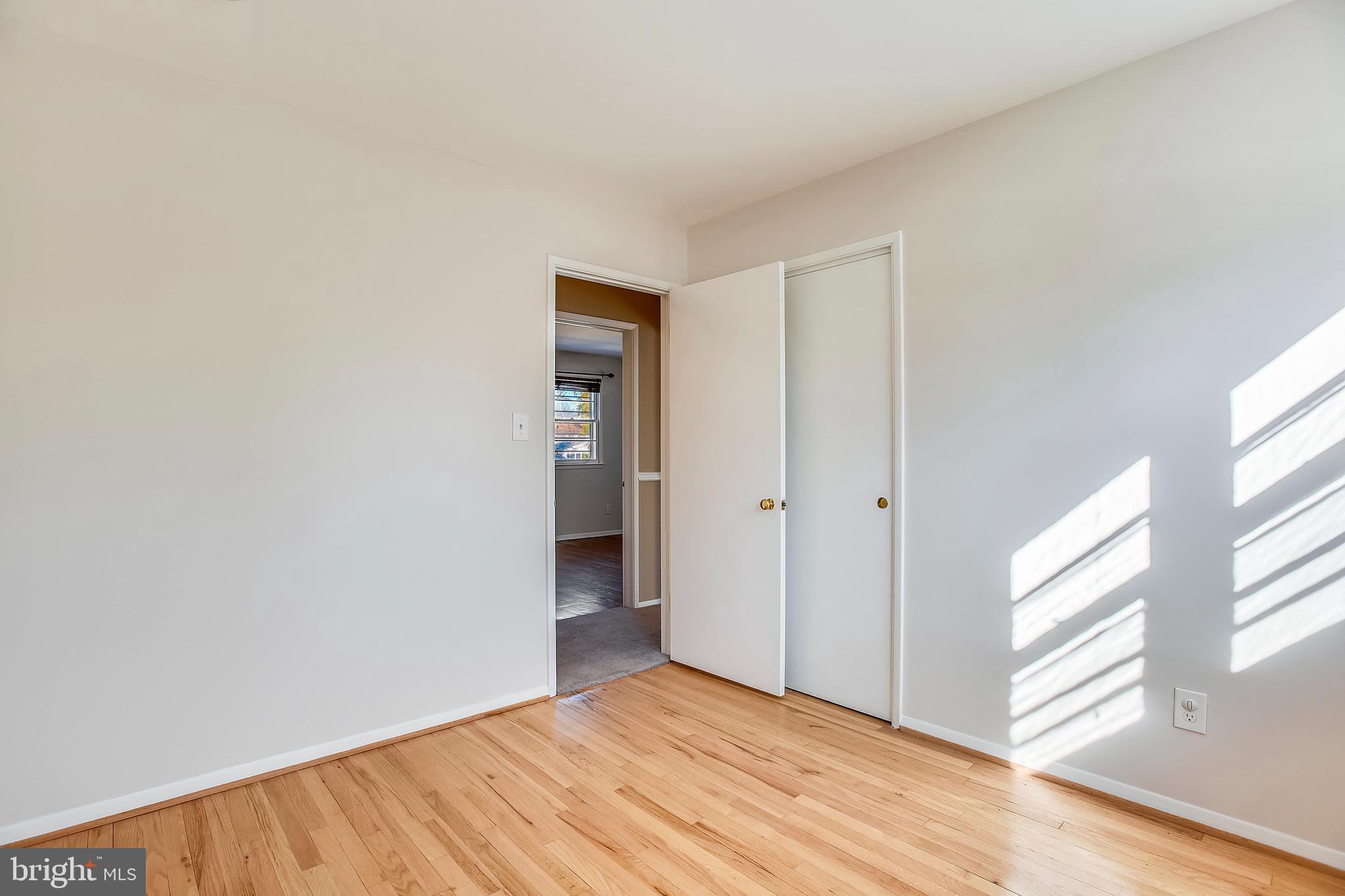 7308 Foxe Place Springfield, VA 22151 - Photo 27 of 38 a view of an empty room with wooden floor and a window