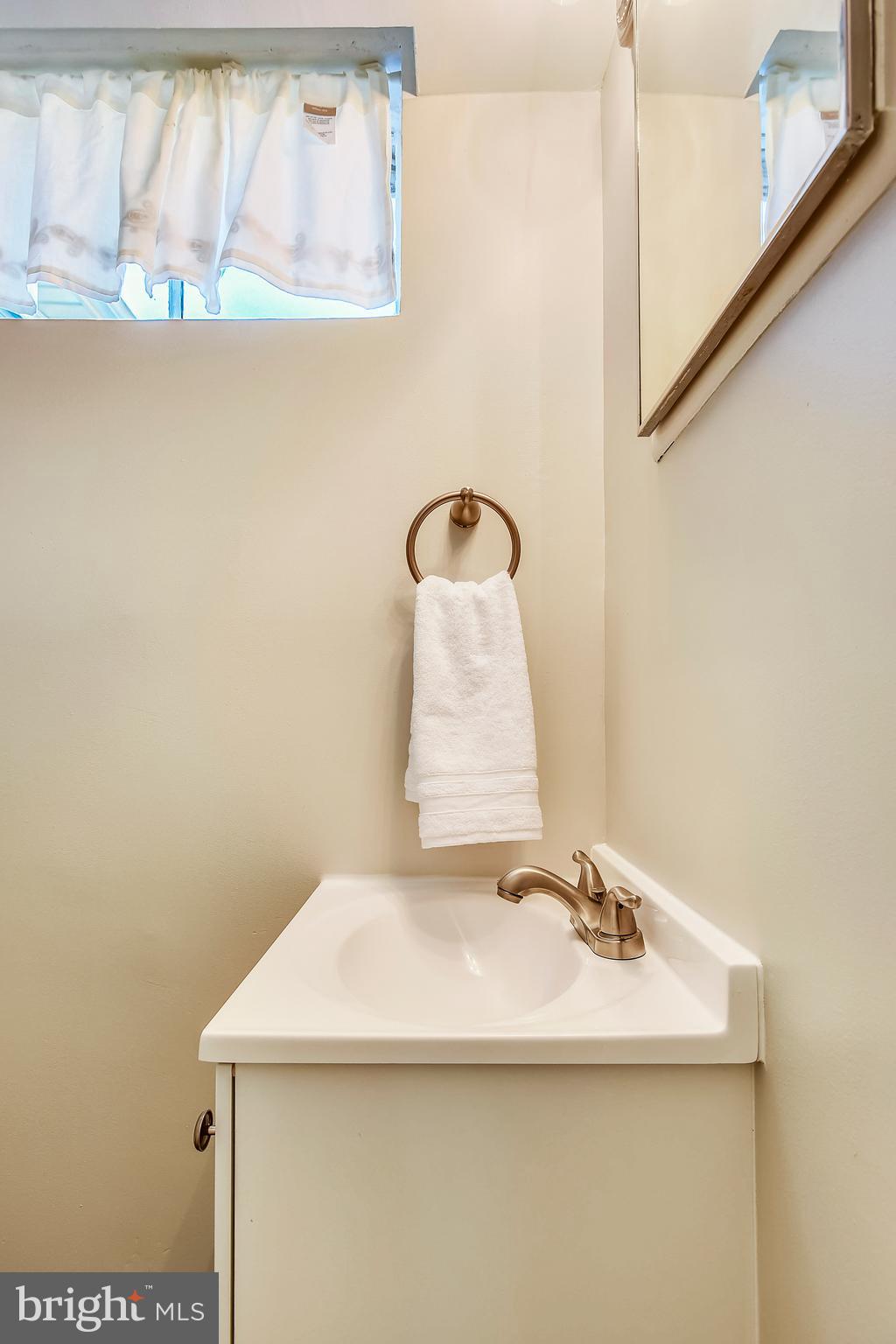7308 Foxe Place Springfield, VA 22151 - Photo 33 of 38 a bathroom with a sink and a mirror