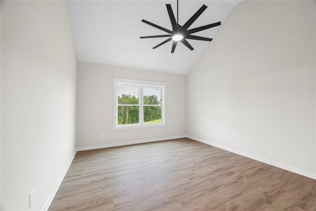 731 Racetrack Road Toccoa, GA 30577 - Photo 4 of 7 an empty room with wooden floor and windows