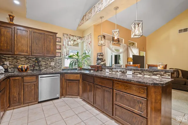 a kitchen with stainless steel appliances granite countertop a sink and cabinets