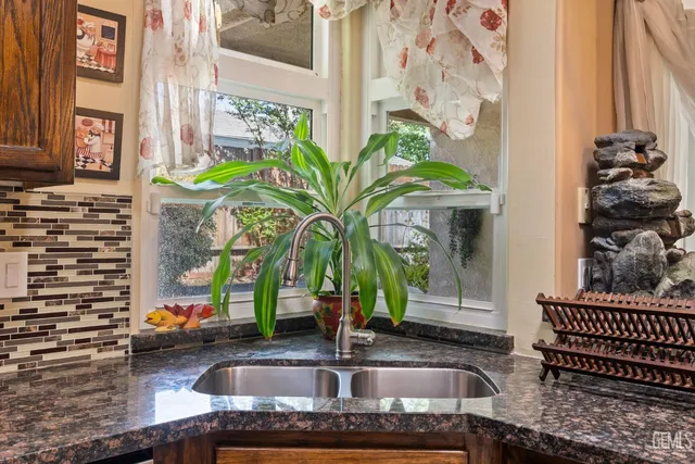 a view of a dining room with furniture and a chandelier